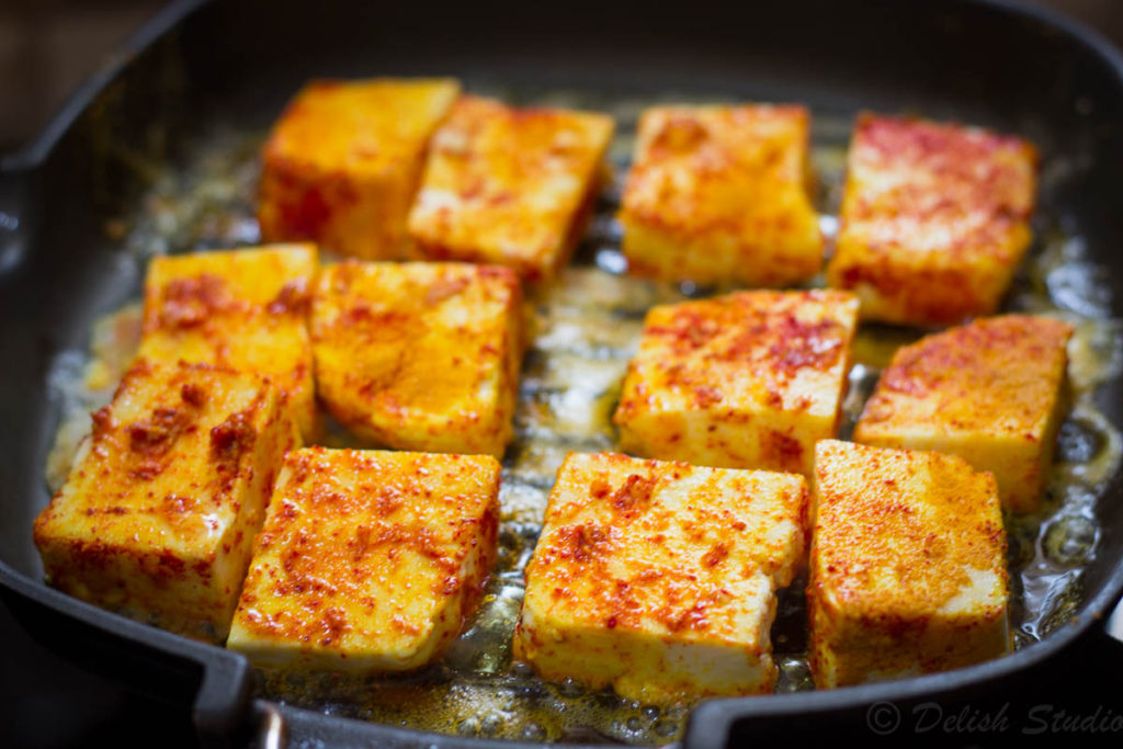 cottage cheese pieces being grilled in paneer for making keto paneer makhani (low carb) recipe.