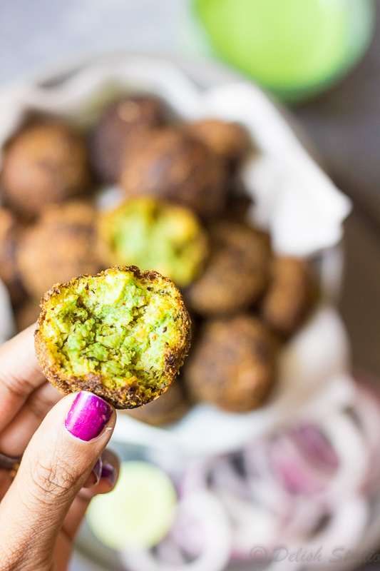 A closeup of a fingers holding Keto Broccoli Cottage cheese balls (low carb) 