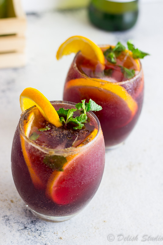 Orange wedges on top of Jaljeera mixed with the goodness of Red wine Sangria is what makes up this tangy, boozy, fizzy refreshing summer cocktail! Super easy to make this is recipe gives an Indian twist to classic Red wine Sangria!